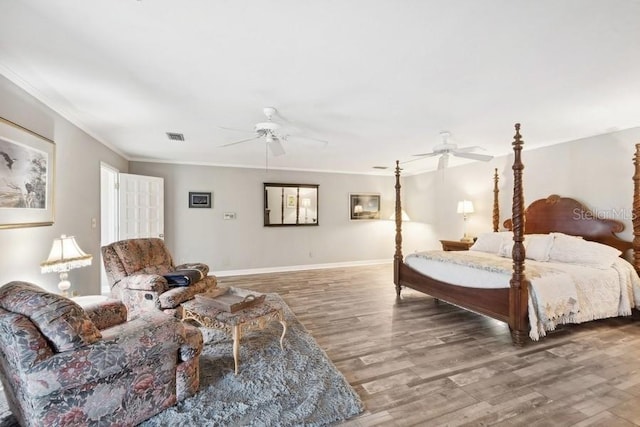 bedroom featuring hardwood / wood-style floors, ceiling fan, and crown molding