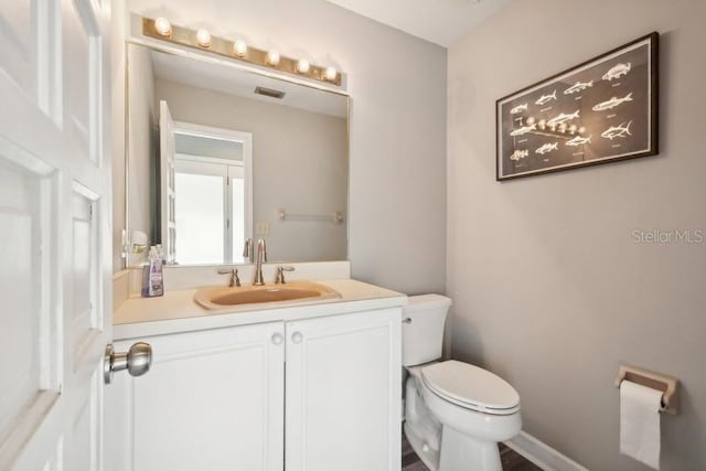 bathroom with vanity and toilet