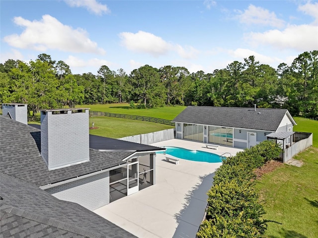 view of swimming pool with a patio area and a yard