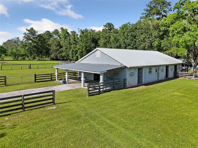 view of stable with a rural view