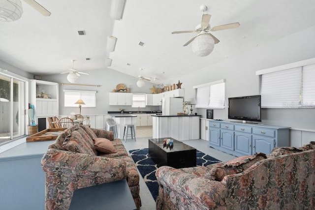 living room with sink and vaulted ceiling