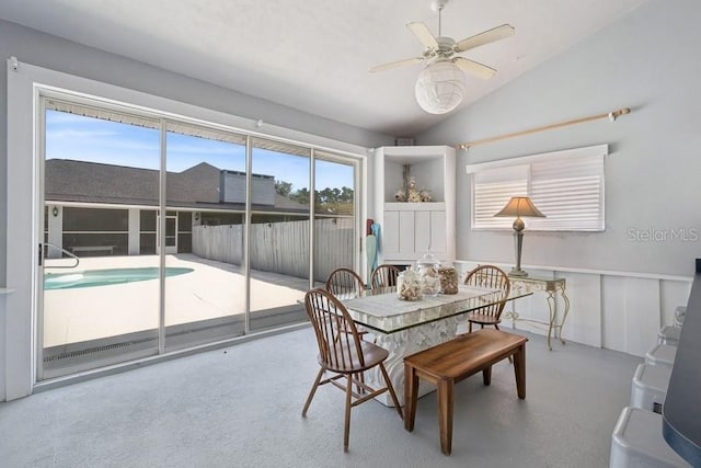 dining space with ceiling fan and lofted ceiling