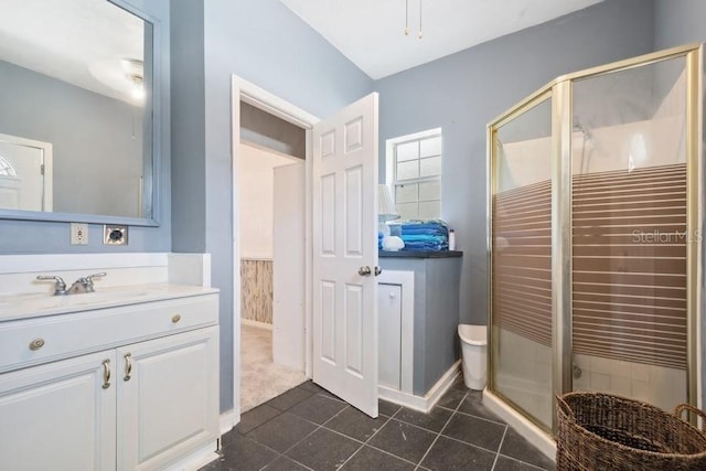 bathroom featuring vanity and a shower with door