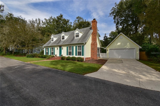 cape cod home with a garage, an outdoor structure, and a front yard