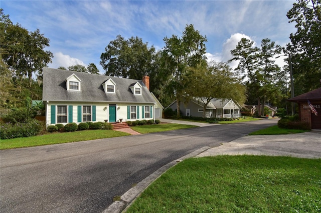 new england style home with a front lawn