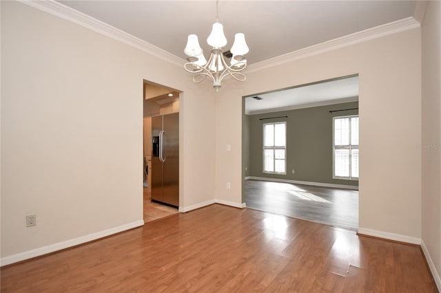 empty room with a chandelier, light wood-type flooring, and ornamental molding