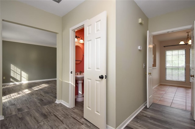 hallway featuring a chandelier and dark hardwood / wood-style floors