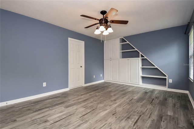 empty room featuring wood-type flooring and ceiling fan