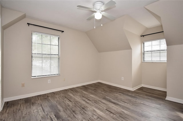 additional living space featuring a wealth of natural light, dark hardwood / wood-style floors, vaulted ceiling, and ceiling fan