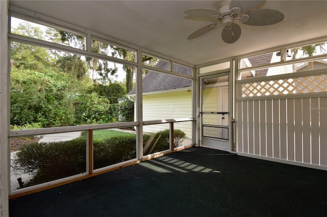 unfurnished sunroom with ceiling fan and a healthy amount of sunlight