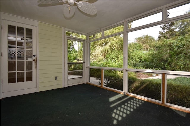 unfurnished sunroom with ceiling fan