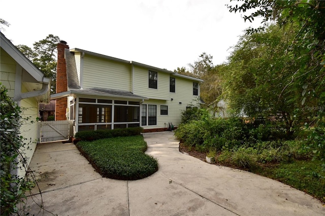 back of property featuring a sunroom