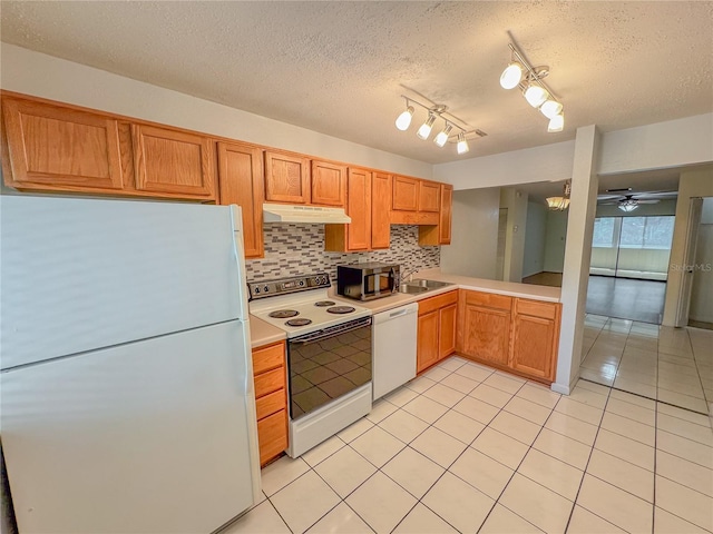 kitchen featuring backsplash, ceiling fan, light tile floors, white appliances, and a textured ceiling