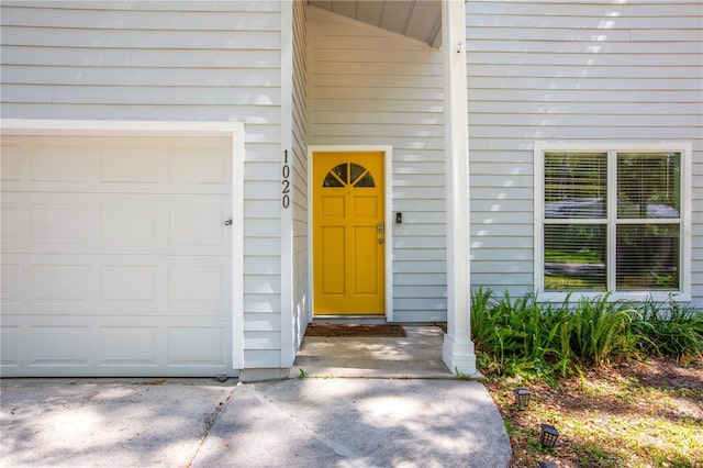 view of exterior entry with a garage