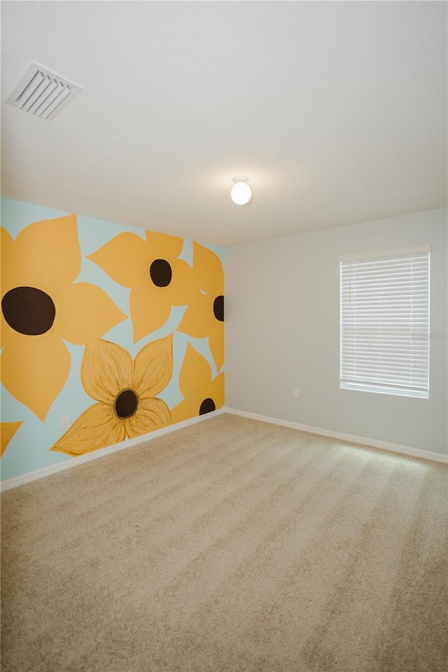 unfurnished room featuring carpet