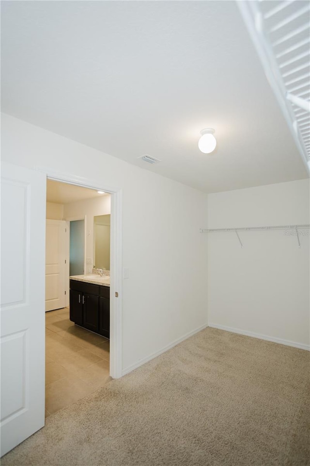 interior space with sink and light tile floors