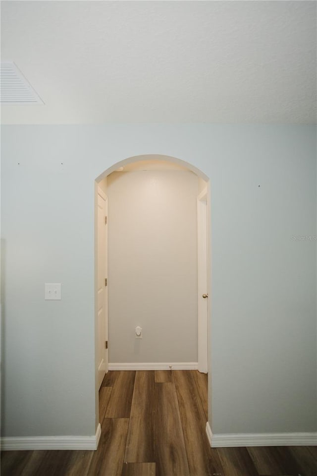 corridor featuring dark wood-type flooring