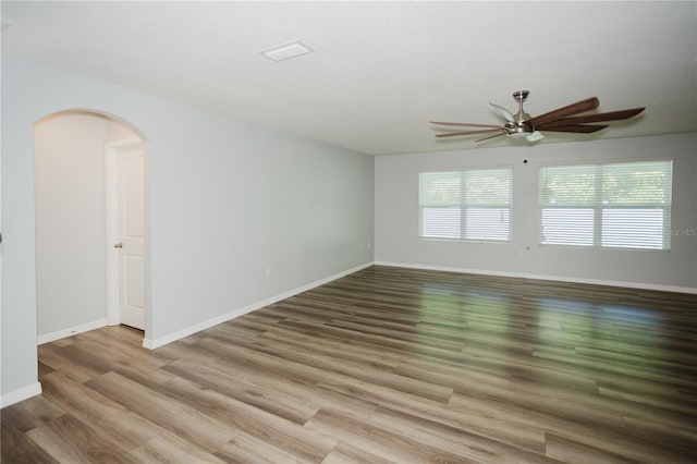 spare room featuring wood-type flooring and ceiling fan