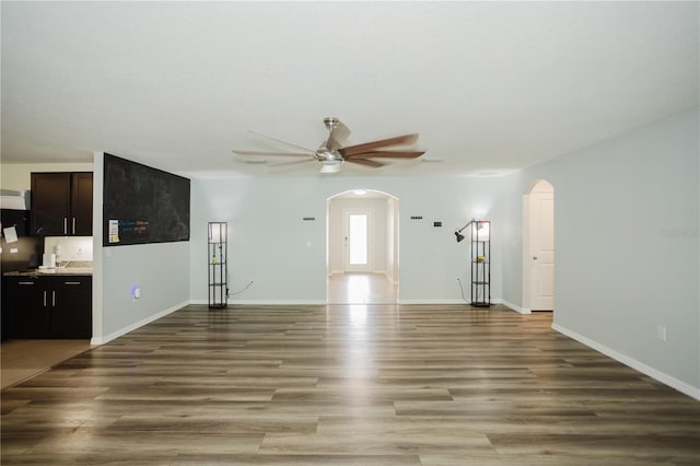 unfurnished living room with ceiling fan and hardwood / wood-style flooring