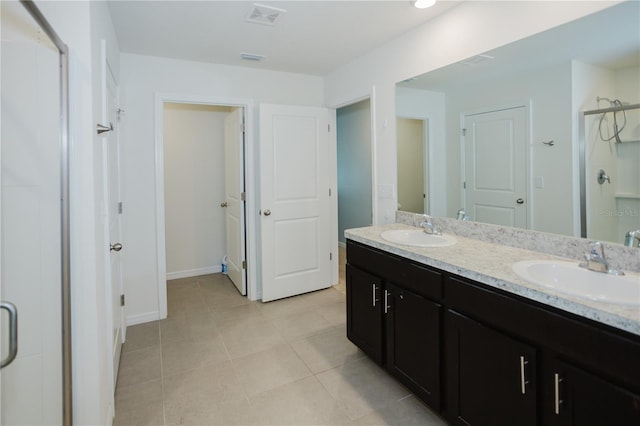 bathroom with tile flooring and double sink vanity