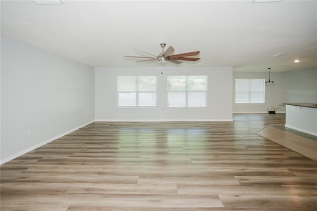 spare room with hardwood / wood-style floors and ceiling fan