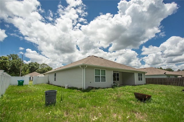 back of property with a yard