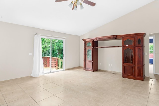 spare room with a wealth of natural light, ceiling fan, and light tile floors