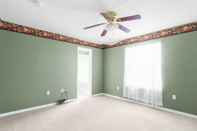 carpeted empty room with a healthy amount of sunlight and ceiling fan