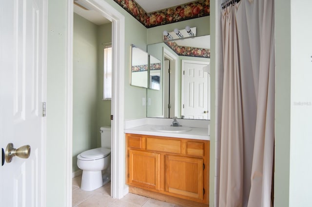 bathroom with vanity, toilet, and tile floors