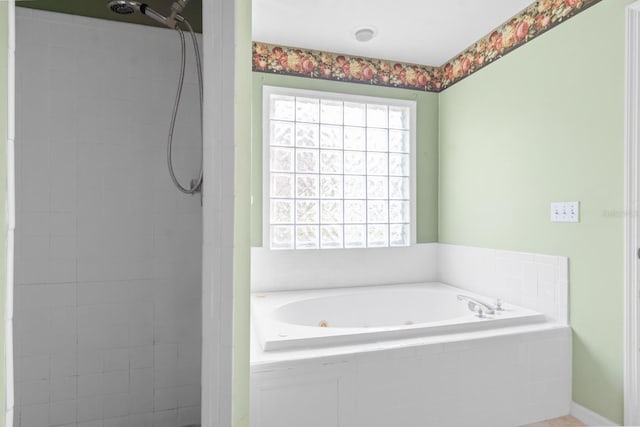 bathroom featuring a relaxing tiled bath