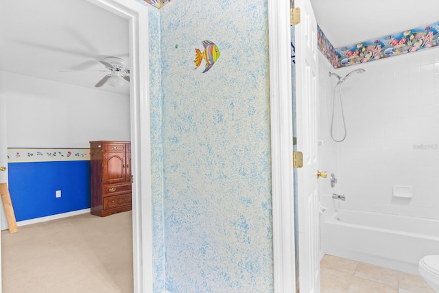 bathroom with tile floors, bathtub / shower combination, ceiling fan, and toilet