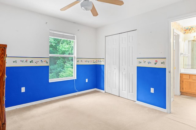 unfurnished bedroom with carpet flooring, a closet, and ceiling fan