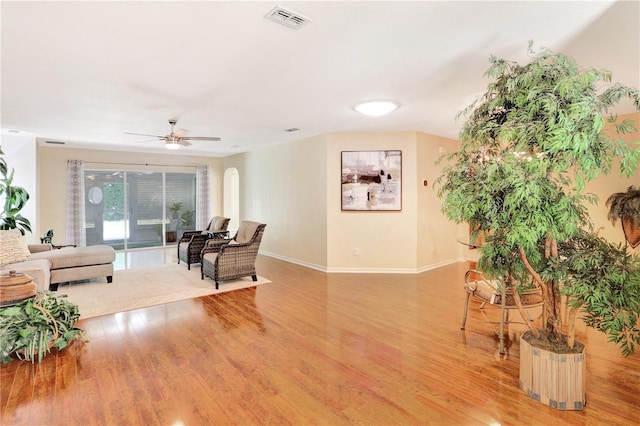 living room featuring ceiling fan and light wood-type flooring