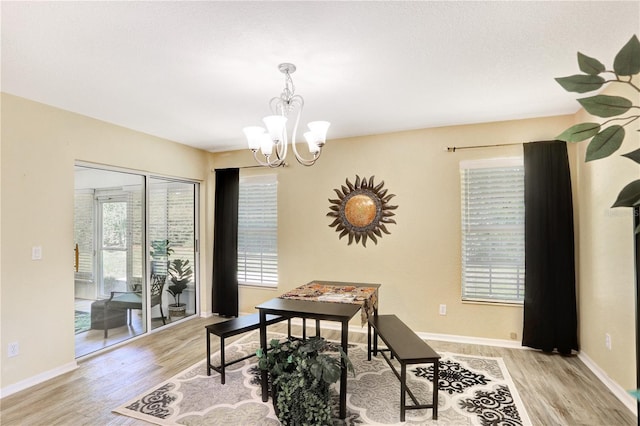 office with a wealth of natural light, a chandelier, and light wood-type flooring