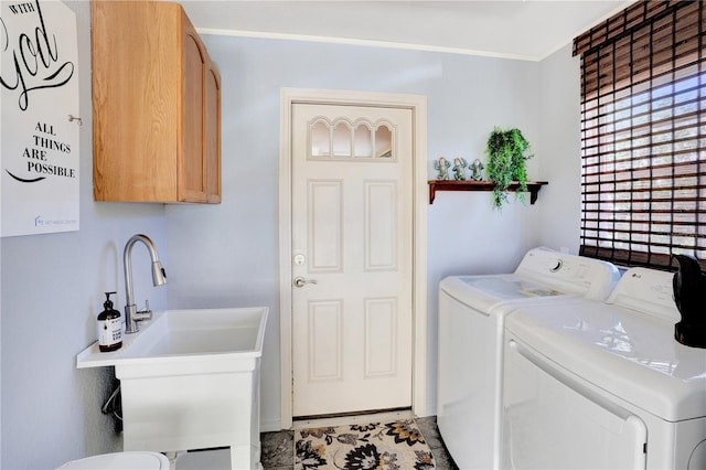 laundry area featuring cabinets and washing machine and clothes dryer