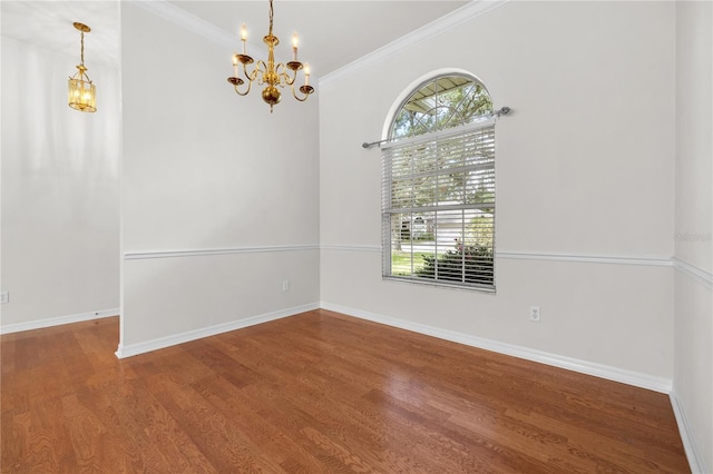 unfurnished room with hardwood / wood-style flooring, crown molding, and an inviting chandelier