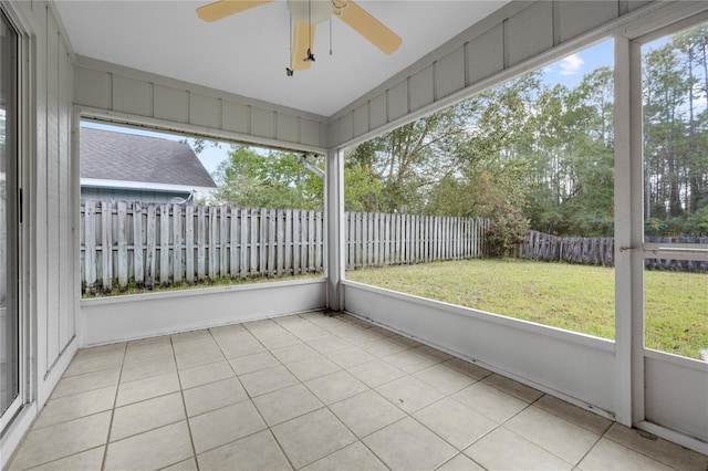 unfurnished sunroom with ceiling fan