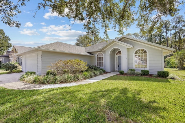 ranch-style house featuring a front lawn and a garage