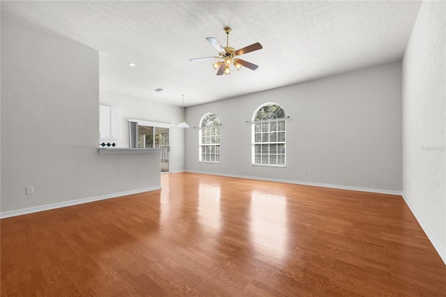 unfurnished living room featuring a textured ceiling, ceiling fan, and light hardwood / wood-style flooring