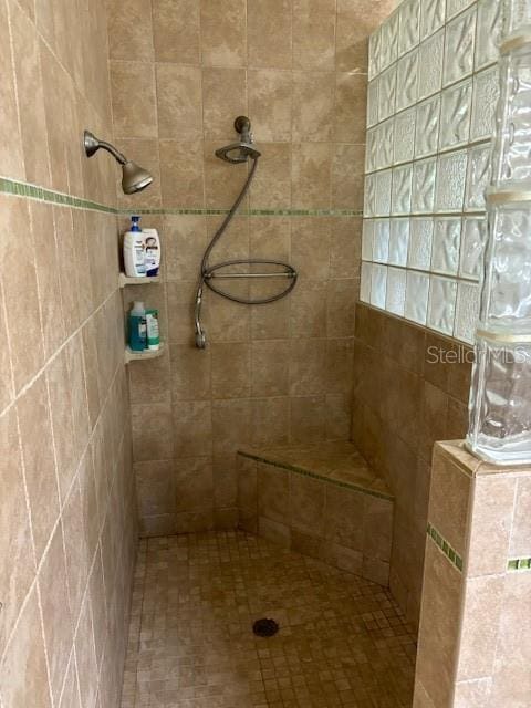 bathroom with a tile shower