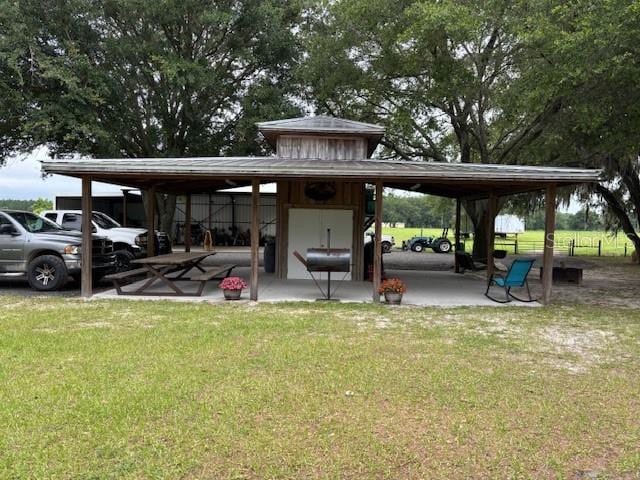 view of home's community with a yard and a patio