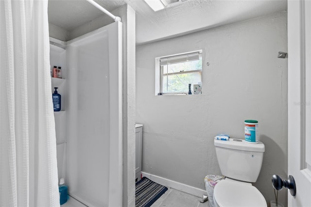 bathroom with walk in shower and toilet