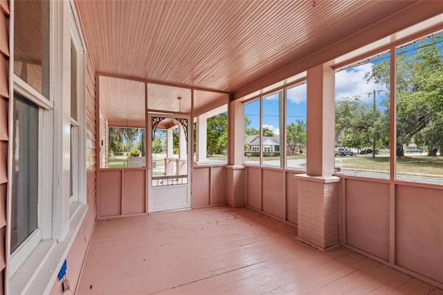 unfurnished sunroom featuring wood ceiling