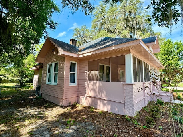 view of property exterior featuring a sunroom