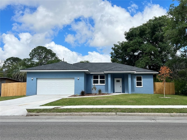 ranch-style home featuring a garage and a front lawn