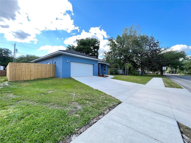 view of property exterior with a garage and a lawn