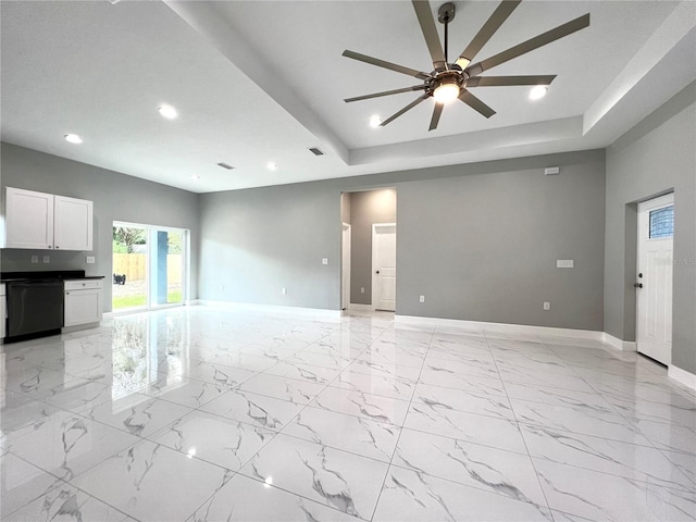 unfurnished living room with ceiling fan, light tile floors, and a raised ceiling