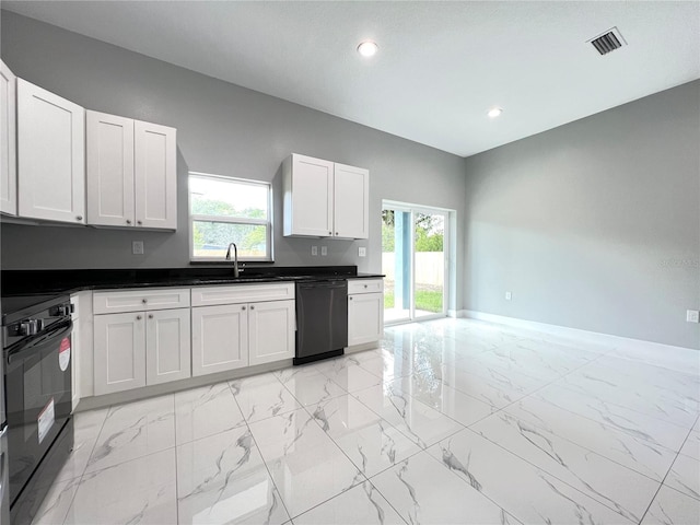 kitchen featuring dishwasher, oven, white cabinetry, sink, and light tile floors