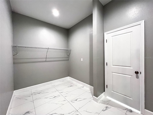 spacious closet with light tile floors