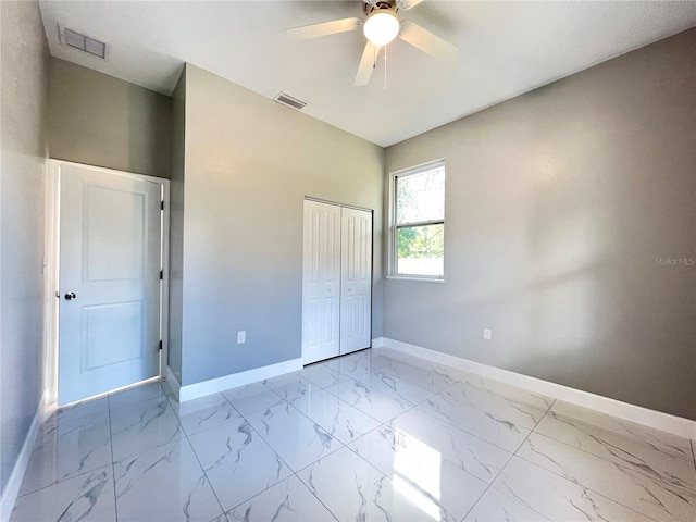 unfurnished bedroom with tile flooring, a closet, and ceiling fan